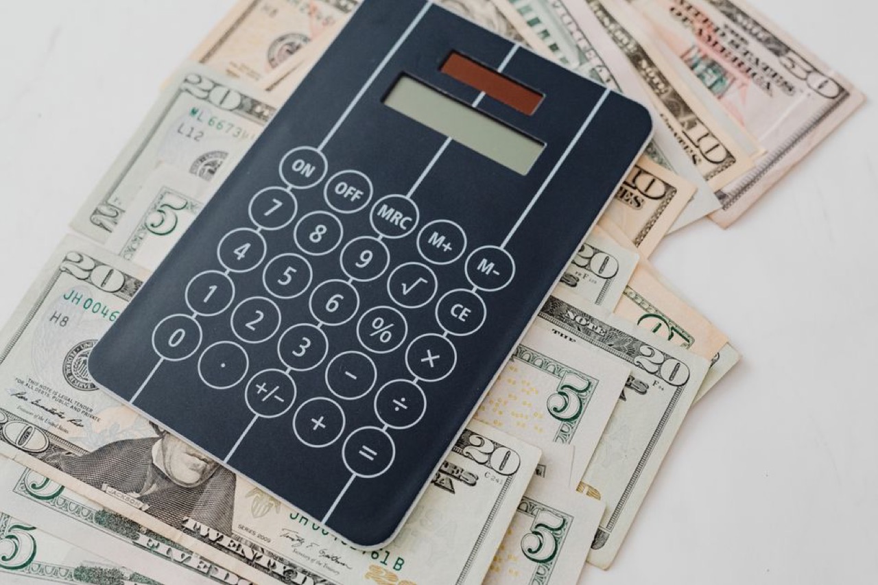 Calculator and money - How Much Car Insurance Cover Do You Need? Insured Value Explained