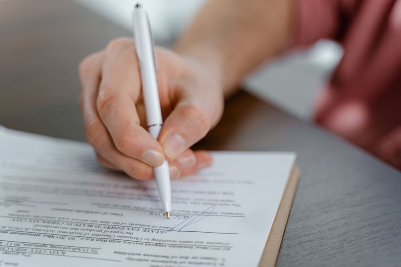 Signing paperwork close up - New Driver Car Insurance Checklist